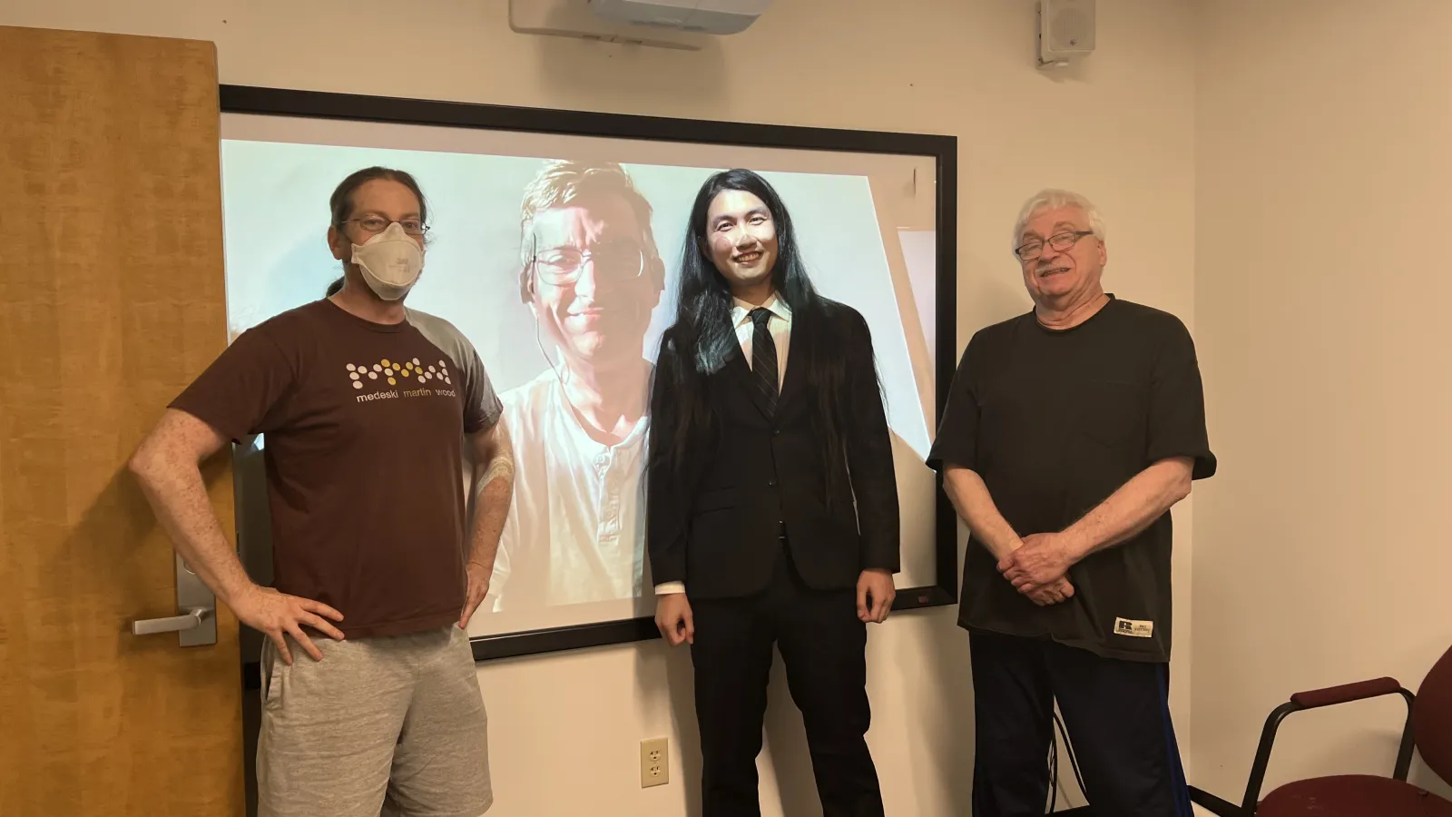 Abe Wang standing with his committee members